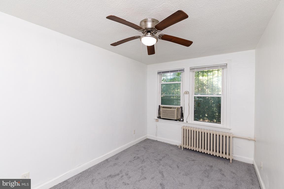 430 Mellon Street Southeast, Unit 2 Washington, DC 20032 - Photo 12 of 20 an empty room with windows and ceiling fan