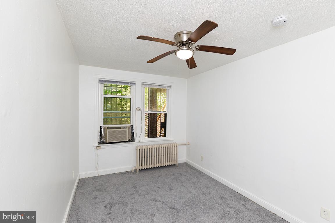 430 Mellon Street Southeast, Unit 2 Washington, DC 20032 - Photo 13 of 20 a living room with a ceiling fan and a window