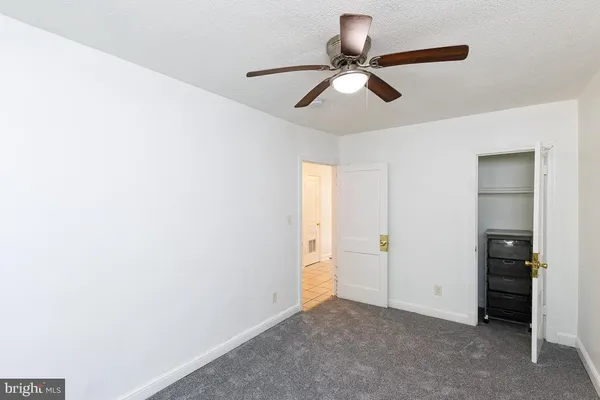 a view of a room with closet and chandelier fan