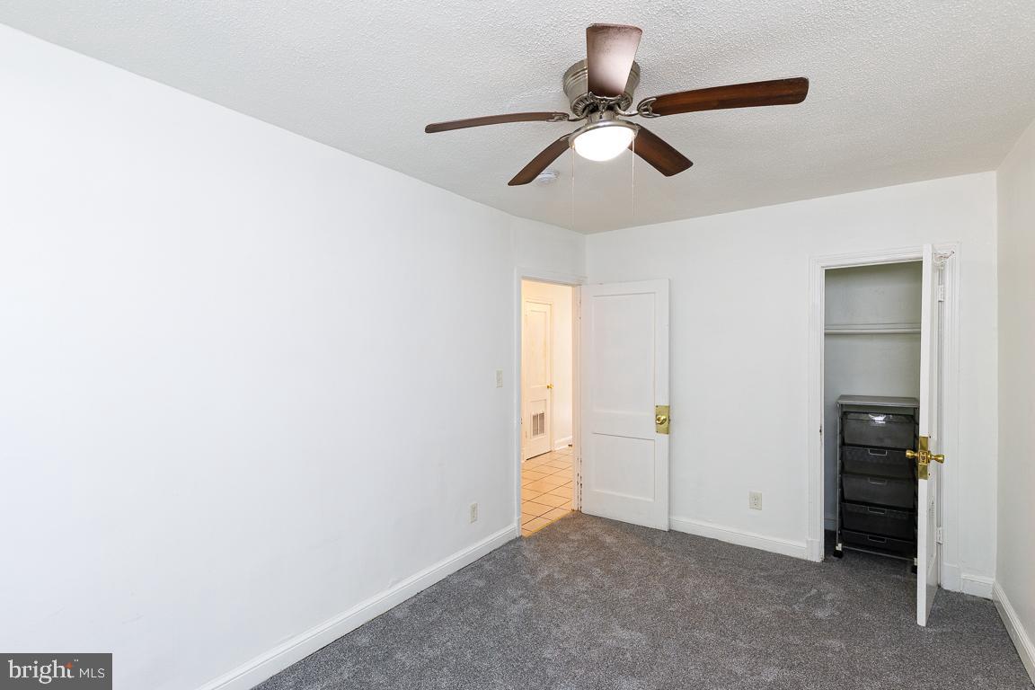 430 Mellon Street Southeast, Unit 2 Washington, DC 20032 - Photo 15 of 20 a view of a room with closet and chandelier fan