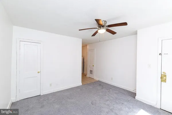 a view of a ceiling fan and hardwood floor