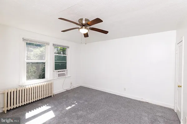 a view of a livingroom with a ceiling fan and window