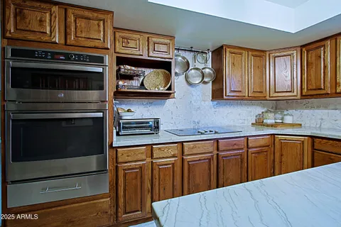 a living room with furniture gym equipment and a large window