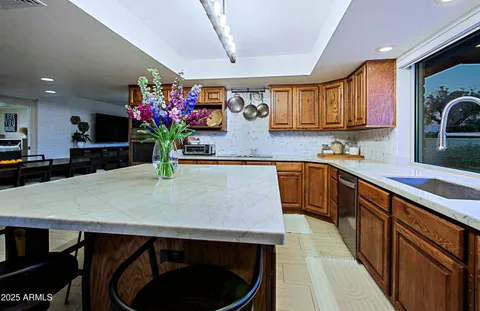 a bathroom with a sink a toilet a mirror and shower