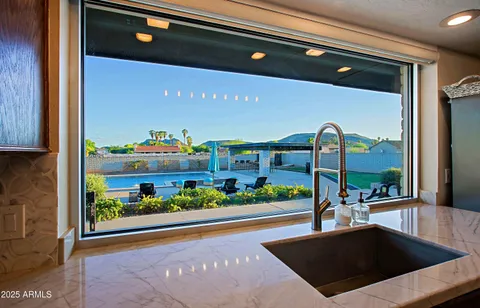 view of a brick house with a lot of flower plants