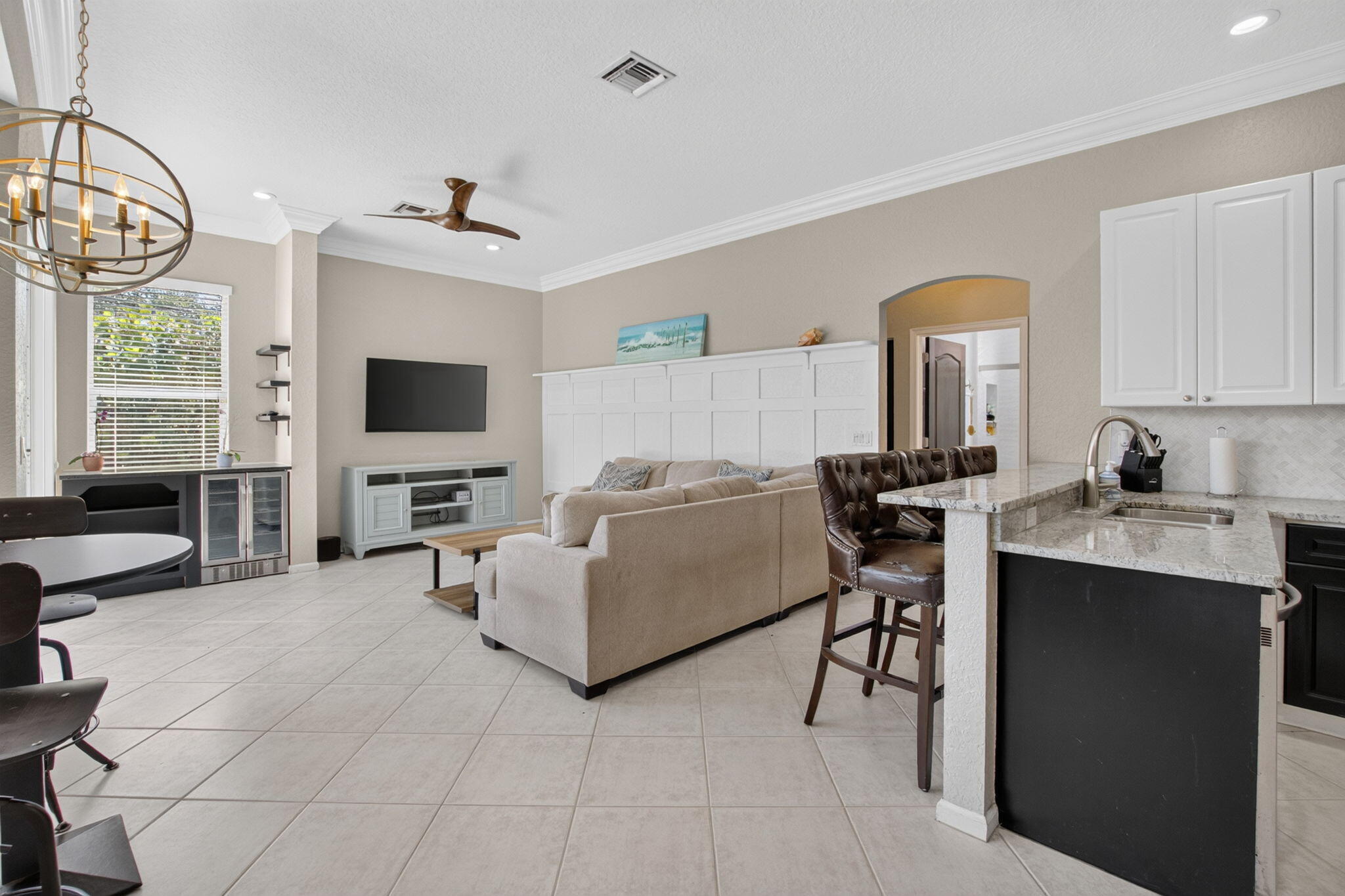 1365 East Barwick Ranch Circle Delray Beach, FL 33445 - Photo 28 of 77 a living room with furniture a flat screen tv and a window