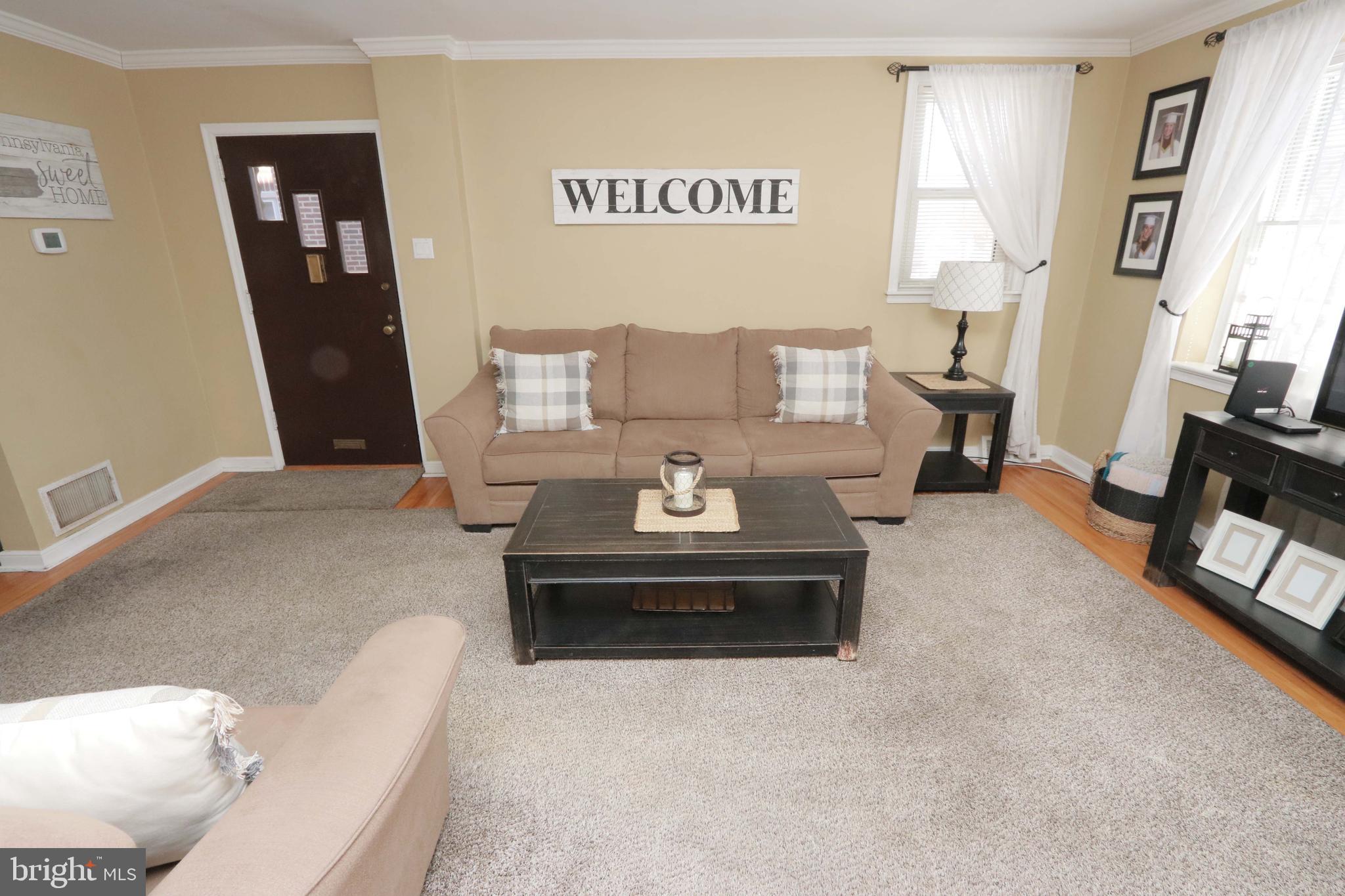 8134 Revere Street Philadelphia, PA 19152 - Photo 18 of 49 a living room with furniture and a fireplace