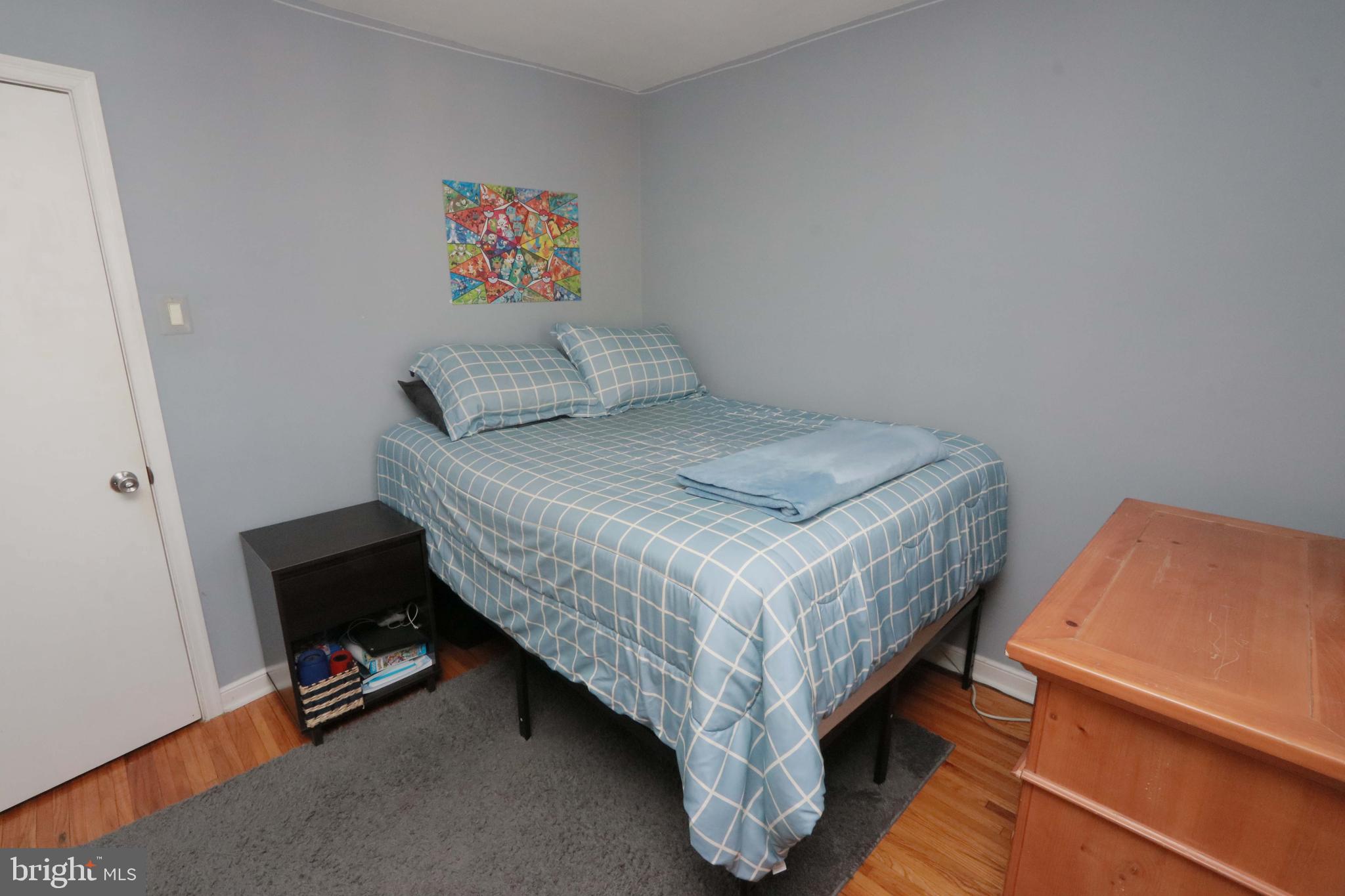 8134 Revere Street Philadelphia, PA 19152 - Photo 33 of 49 a bedroom with a bed and a dresser next to a window