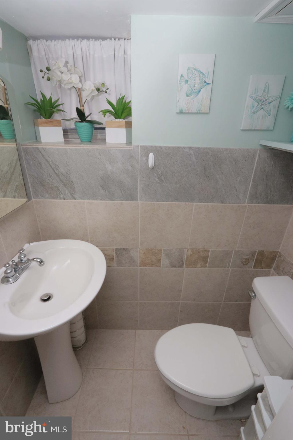 8134 Revere Street Philadelphia, PA 19152 - Photo 43 of 49 a bathroom with a sink a toilet and a mirror