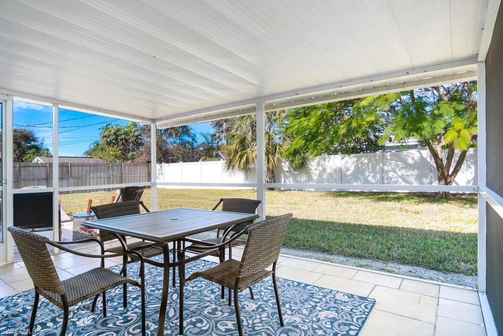 1207 Hernando Street Naples, FL 34103 - Photo 14 of 37 a view of swimming pool with a table and chairs in patio