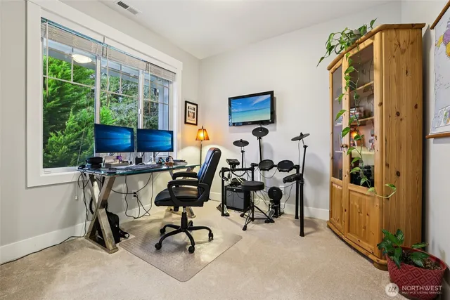 a view of a workspace with furniture and a window