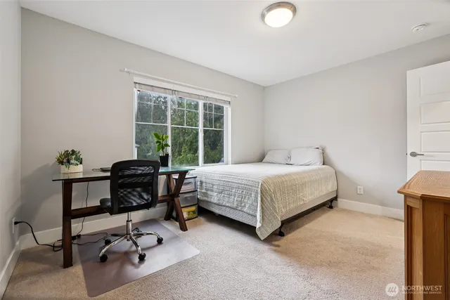 a bedroom with a bed and a desk