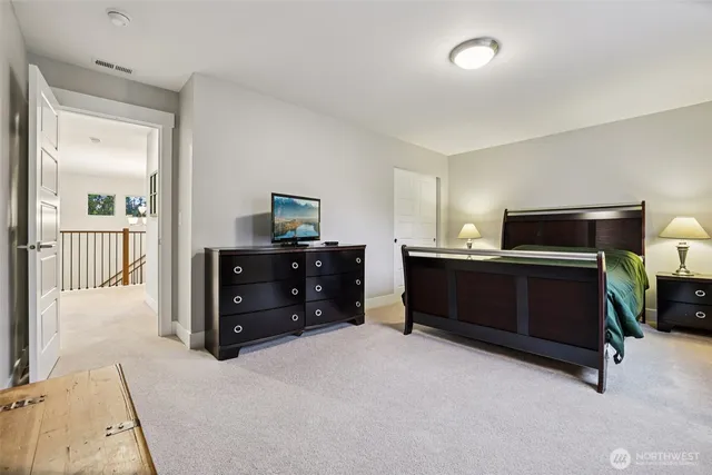 a bedroom with a bed and a dresser