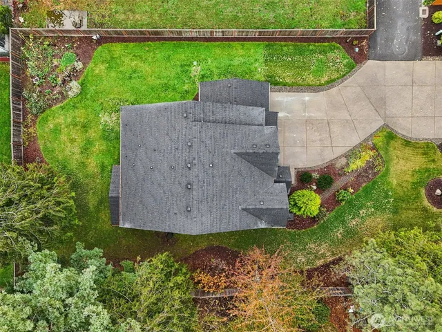 an aerial view of a house with garden space and street view