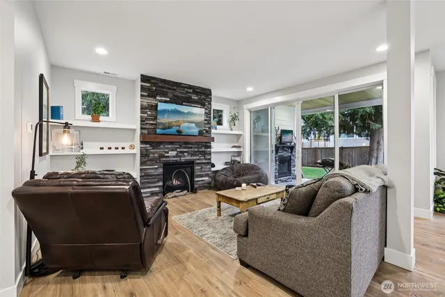 a living room with fireplace furniture and a flat screen tv