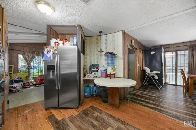 a kitchen with refrigerator a sink and a large window