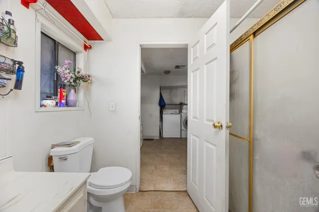 a kitchen with cabinets and wooden floor