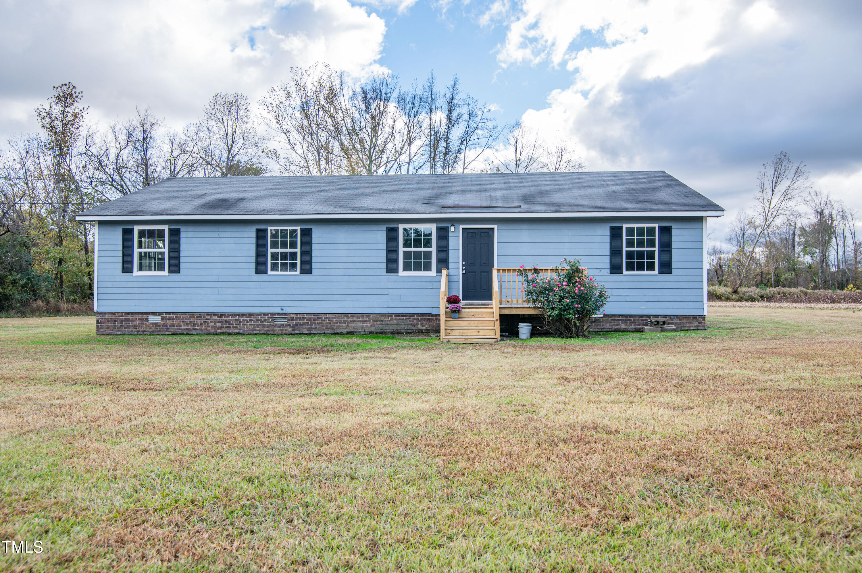 5046 Mrs Mag Road Conway, NC 27820 - Photo 1 of 38 a front view of house with yard and trees in the background
