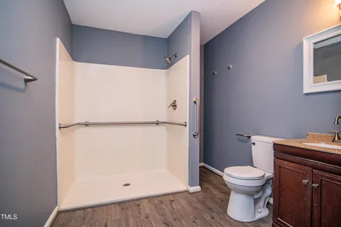 a white toilet sitting next to a bathroom sink