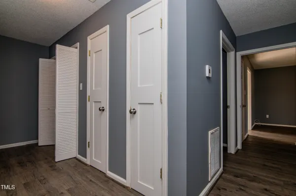 a view of a hallway with wooden floor