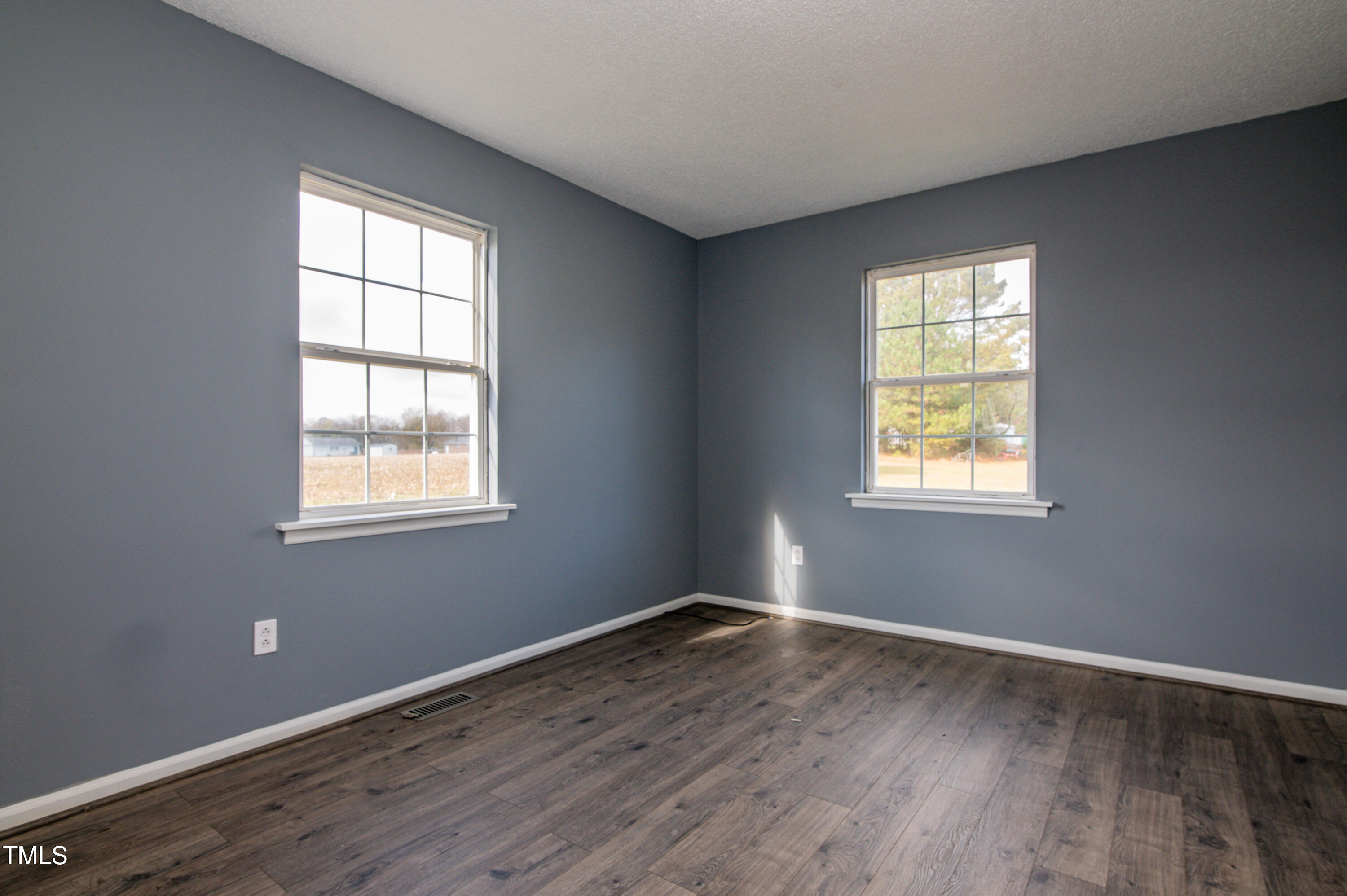 5046 Mrs Mag Road Conway, NC 27820 - Photo 22 of 38 an empty room with wooden floor and windows