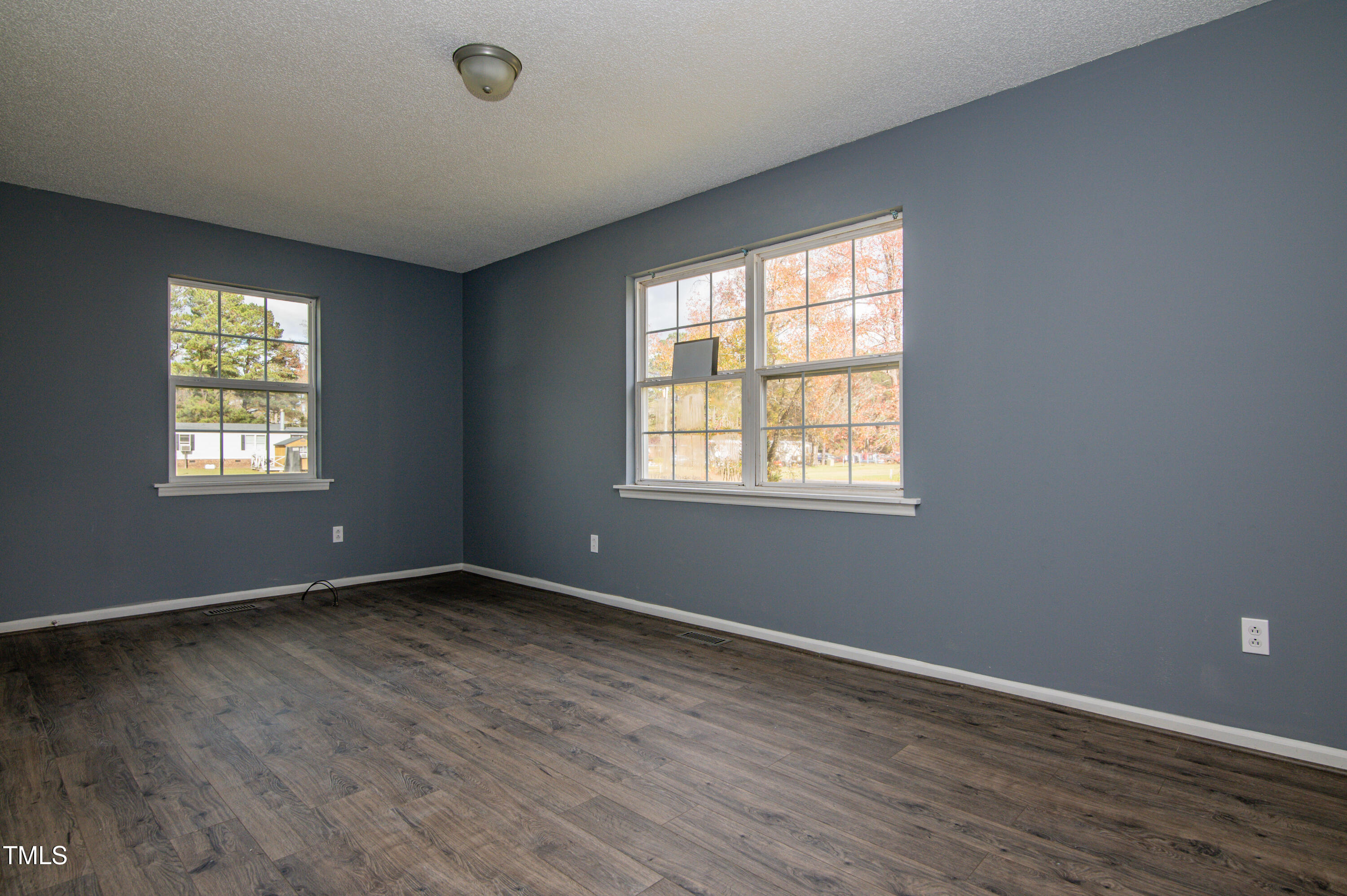 5046 Mrs Mag Road Conway, NC 27820 - Photo 24 of 38 an empty room with wooden floor and windows