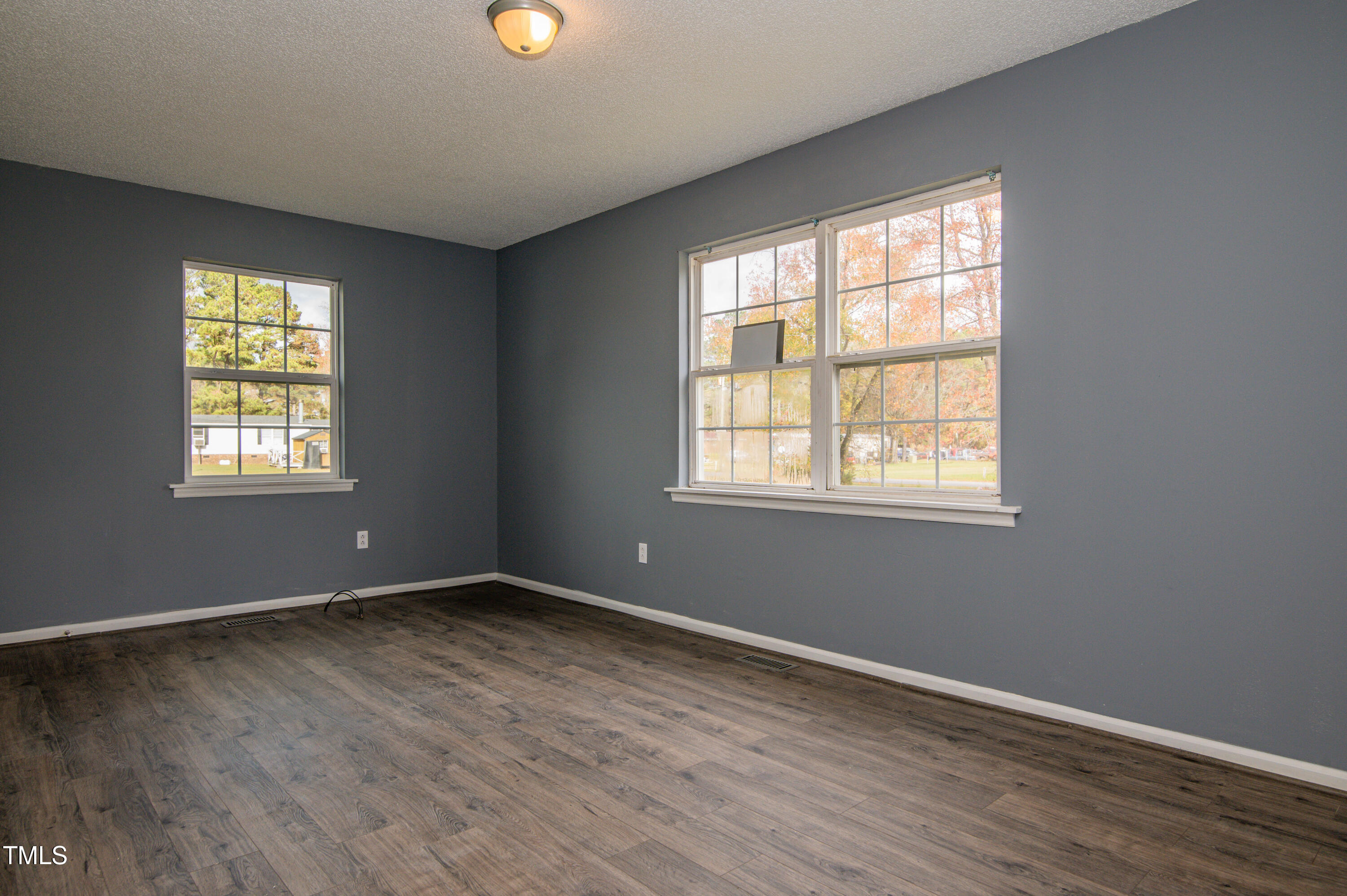 5046 Mrs Mag Road Conway, NC 27820 - Photo 26 of 38 a view of an empty room with wooden floor and a window