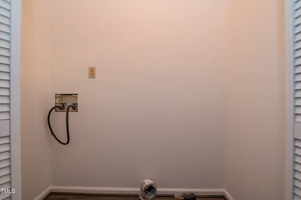 a view of hallway with wooden floor