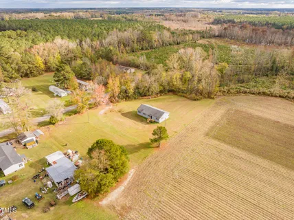 a house view with swimming pool in front of it