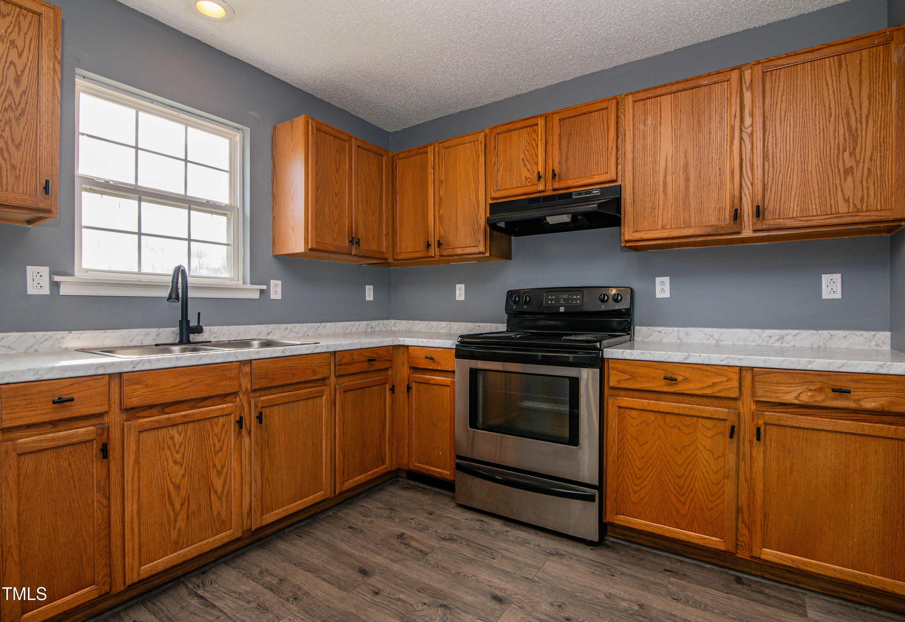 5046 Mrs Mag Road Conway, NC 27820 - Photo 5 of 38 a kitchen with granite countertop wooden cabinets and a stove top oven