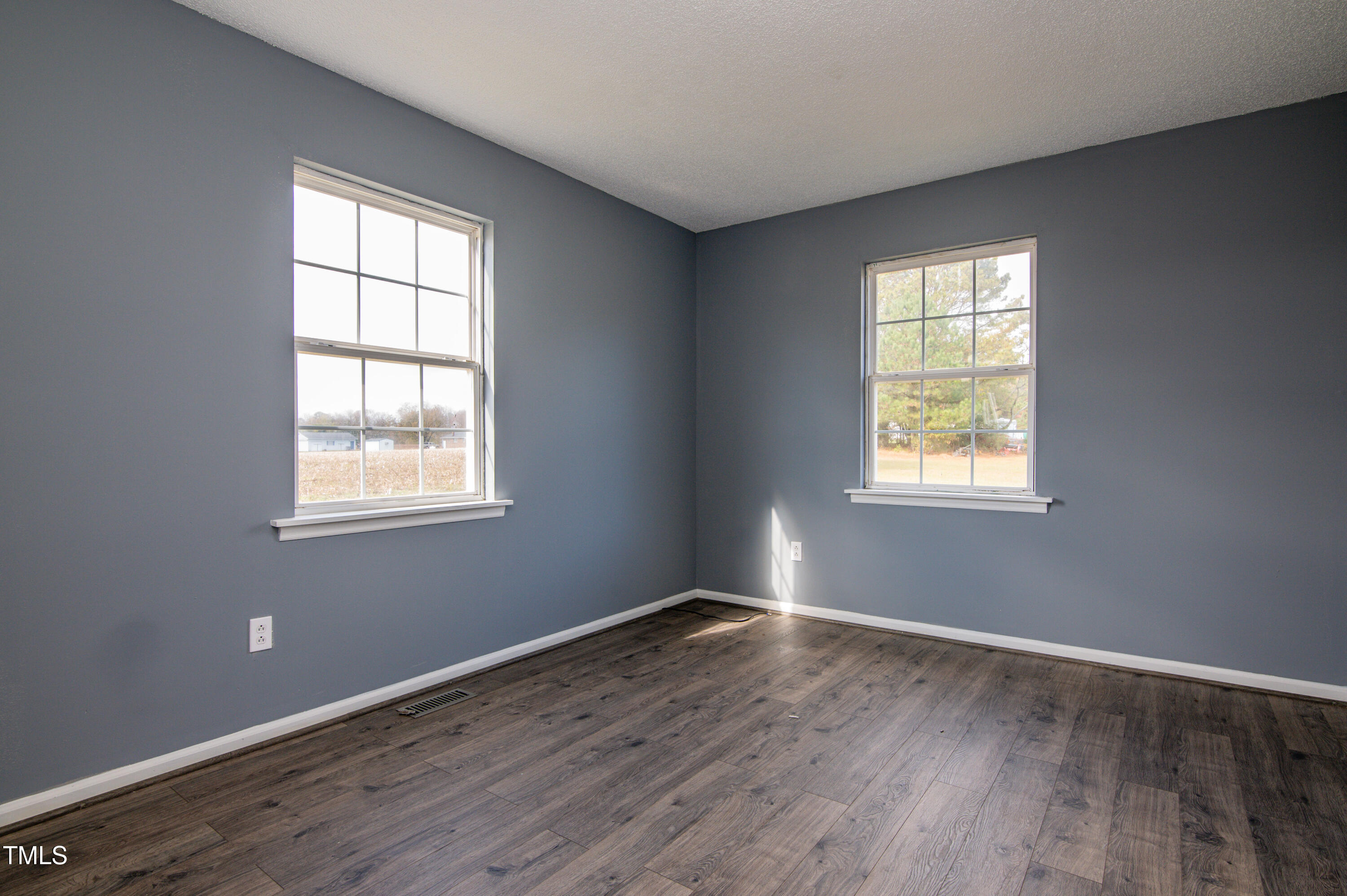 5046 Mrs Mag Road Conway, NC 27820 - Photo 10 of 38 an empty room with wooden floor and windows