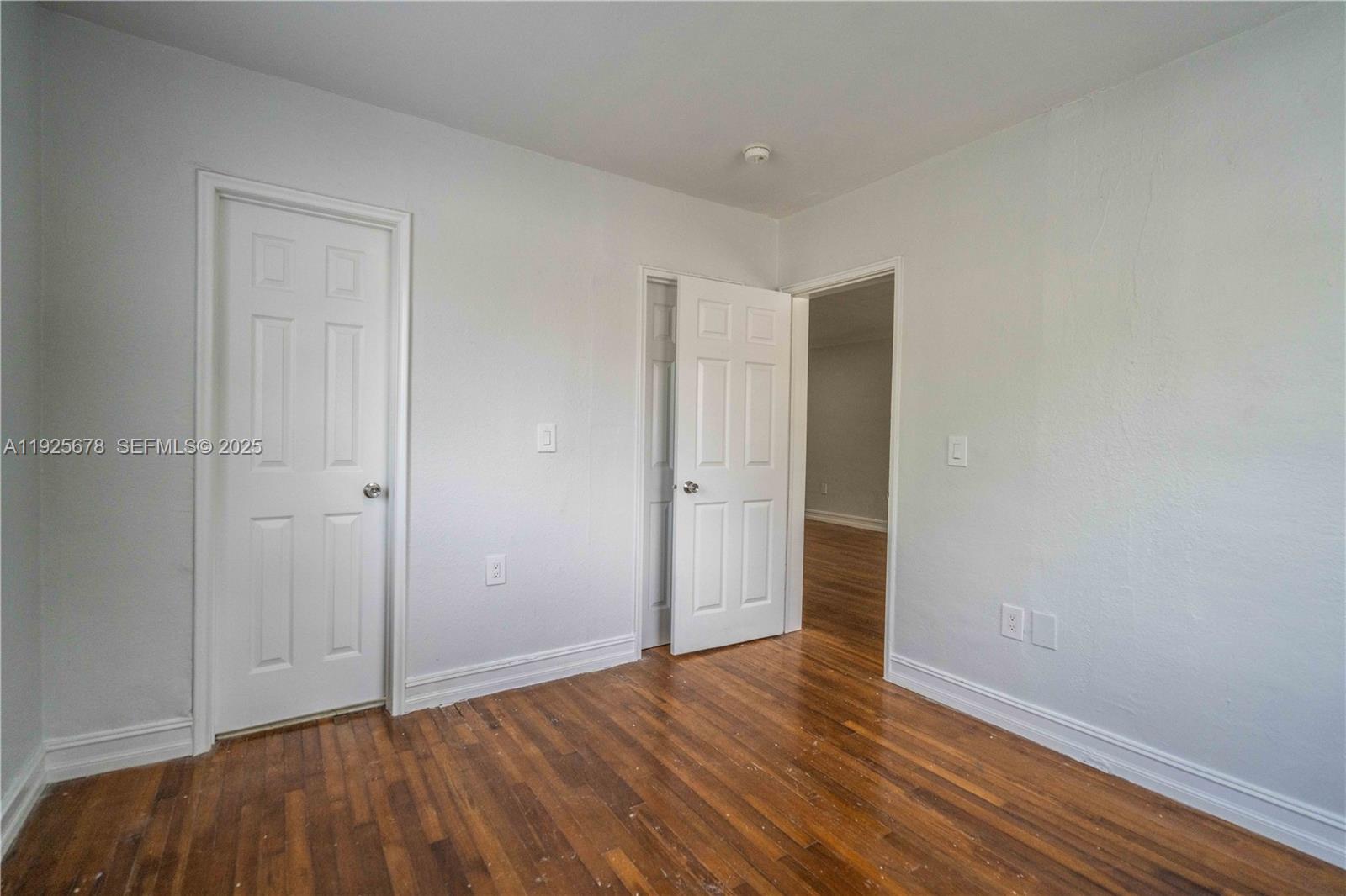 7925 Hawthorne Avenue, Unit 1 Miami Beach, FL 33141 - Photo 12 of 20 a view of an empty room with wooden floor