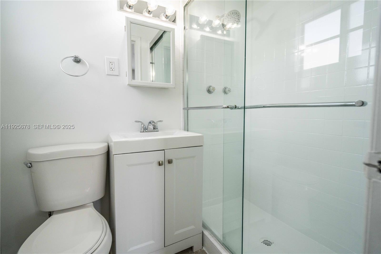 7925 Hawthorne Avenue, Unit 1 Miami Beach, FL 33141 - Photo 14 of 20 a white toilet sitting next to a bathroom sink
