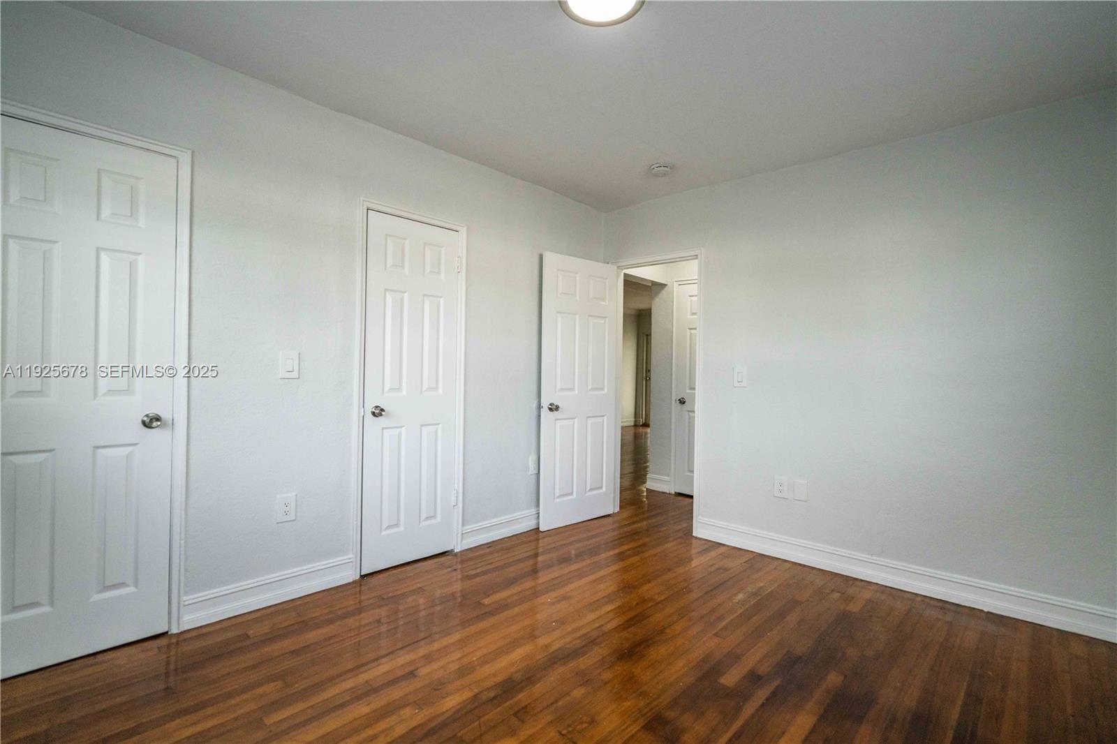 7925 Hawthorne Avenue, Unit 1 Miami Beach, FL 33141 - Photo 17 of 20 a view of an empty room with wooden floor