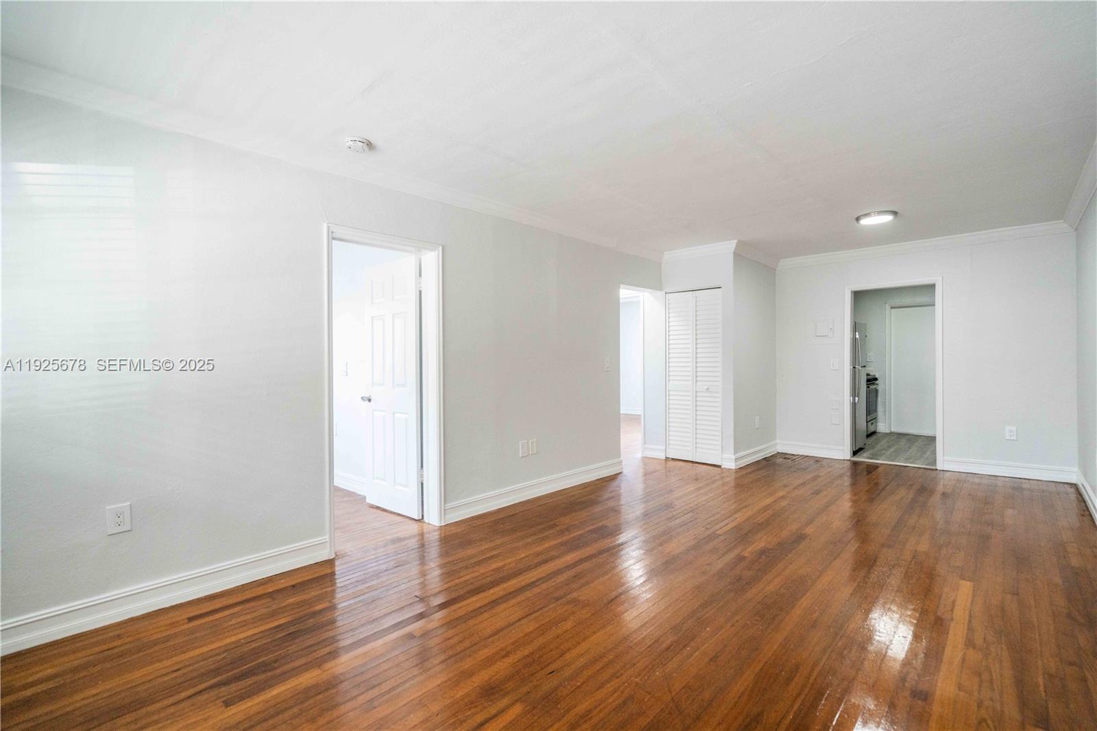 7925 Hawthorne Avenue, Unit 1 Miami Beach, FL 33141 - Photo 6 of 20 a view of an empty room with wooden floor