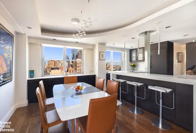 a large kitchen with a table and chairs