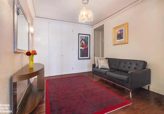 a living room with furniture and a chandelier