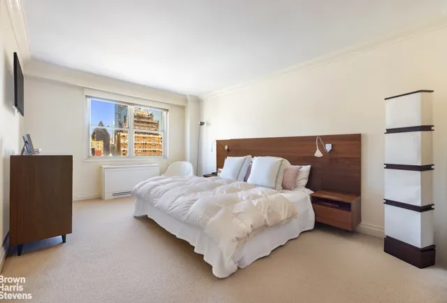 a bedroom with a bed and dresser