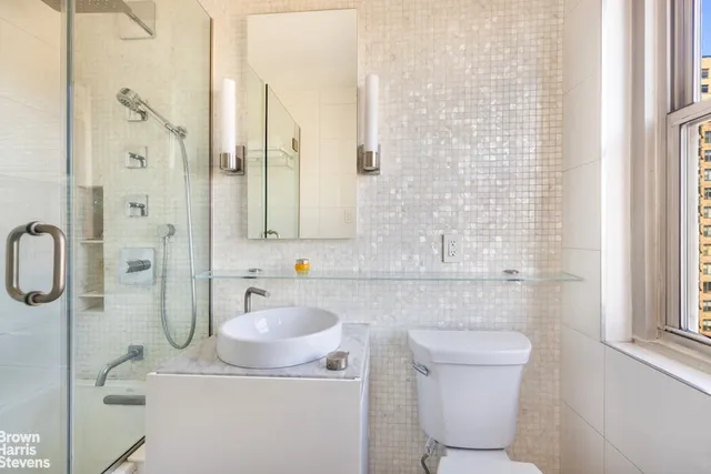 a bathroom with a sink toilet and shower