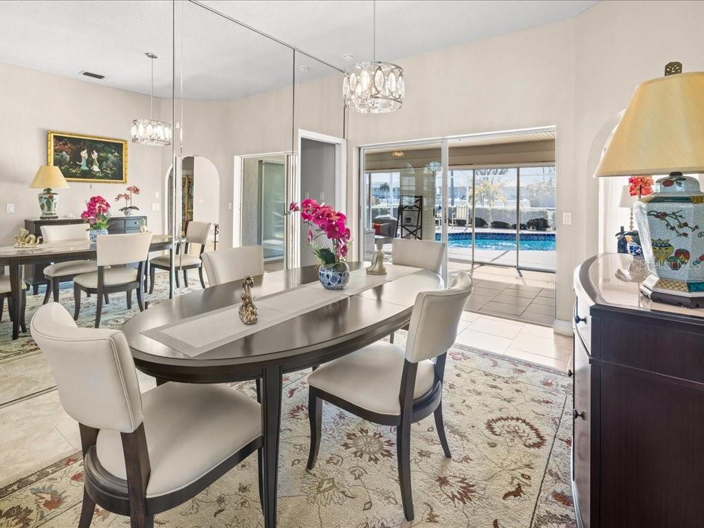 25263 Padre Lane Punta Gorda, FL 33983 - Photo 13 of 60 a view of a dining room with furniture and chandelier