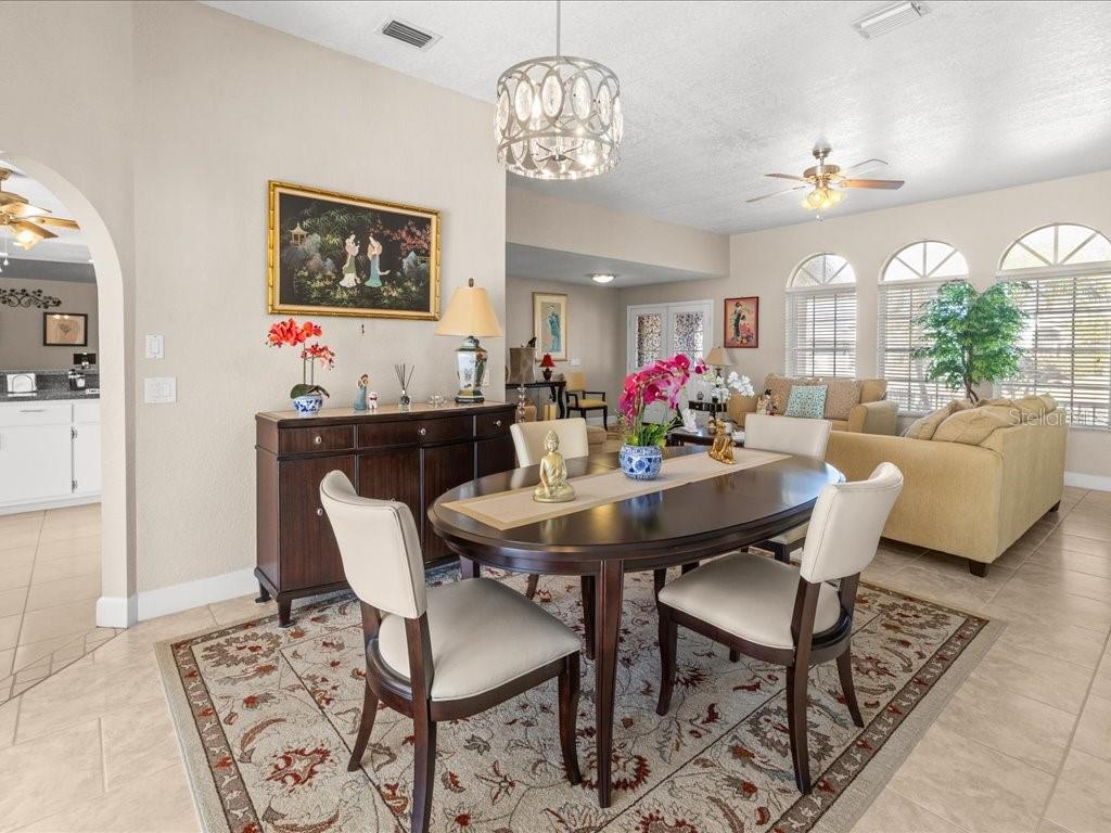 25263 Padre Lane Punta Gorda, FL 33983 - Photo 14 of 60 a view of a dining room with furniture and chandelier