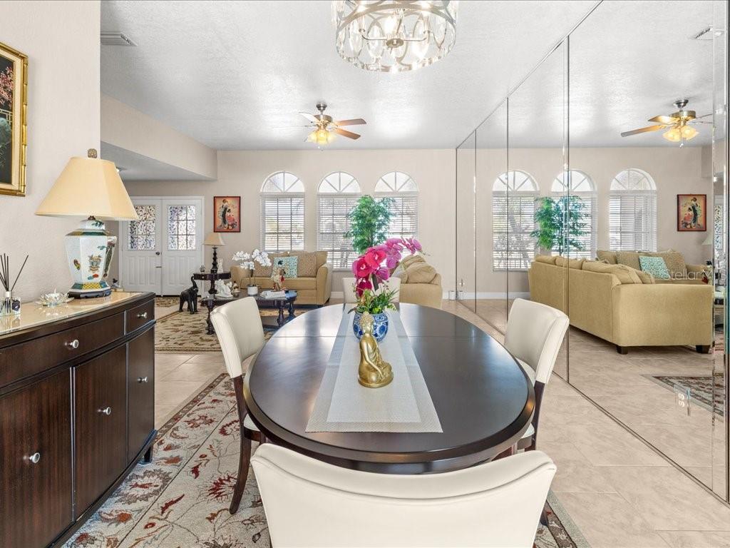 25263 Padre Lane Punta Gorda, FL 33983 - Photo 15 of 60 a view of a dining room with furniture a chandelier and kitchen view