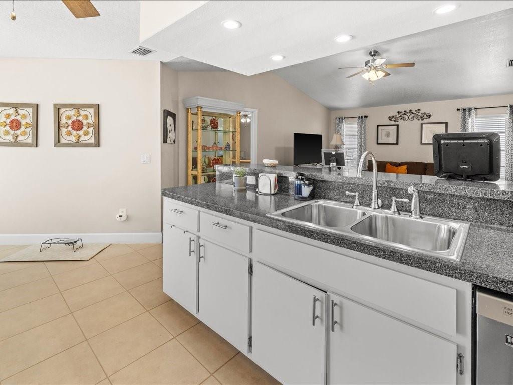 25263 Padre Lane Punta Gorda, FL 33983 - Photo 19 of 60 a kitchen with granite countertop a sink and white cabinets