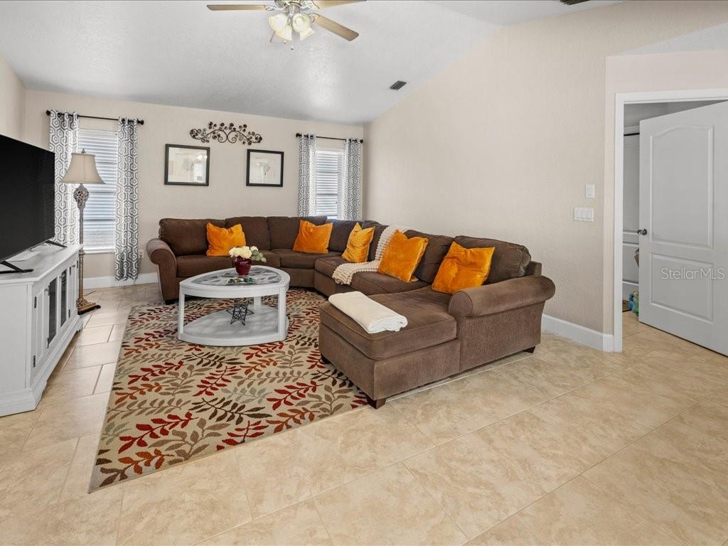 25263 Padre Lane Punta Gorda, FL 33983 - Photo 23 of 60 a living room with furniture and a flat screen tv