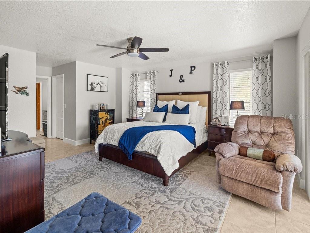 25263 Padre Lane Punta Gorda, FL 33983 - Photo 25 of 60 a spacious bedroom with a bed couch and window