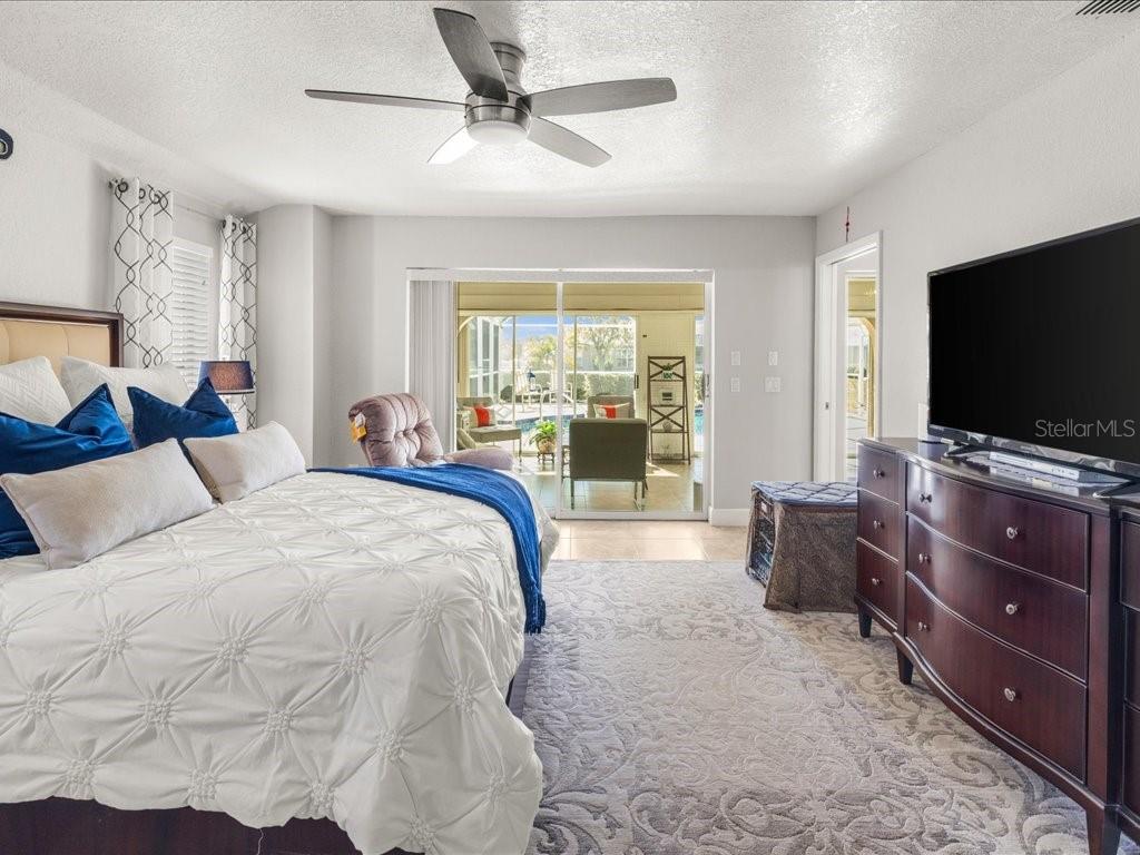 25263 Padre Lane Punta Gorda, FL 33983 - Photo 30 of 60 a spacious bedroom with a bed and a flat screen television