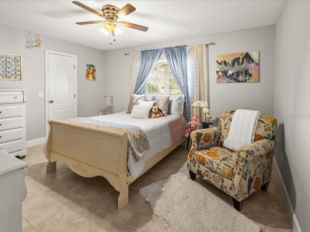 25263 Padre Lane Punta Gorda, FL 33983 - Photo 32 of 60 a bedroom with a bed and a couch