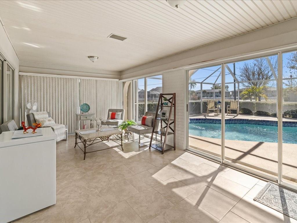 25263 Padre Lane Punta Gorda, FL 33983 - Photo 36 of 60 a living room with furniture and a floor to ceiling window