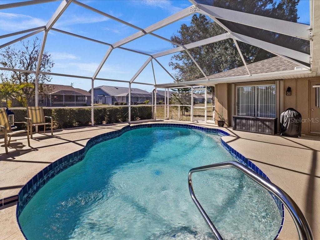 25263 Padre Lane Punta Gorda, FL 33983 - Photo 43 of 60 a view of a swimming pool with a patio and a yard