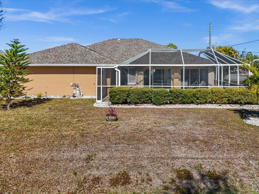 25263 Padre Lane Punta Gorda, FL 33983 - Photo 49 of 60 a front view of a house with a garden